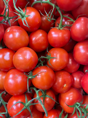 Red bright tomatoes at the market symbolize healthy eating. Organic and fresh tomatoes, just picked and ready to sell or eat. Images of vegetable productsの写真素材