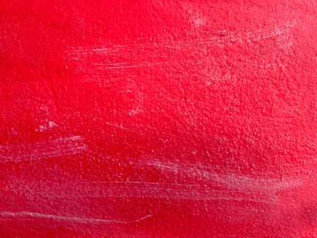 Red painted wall. Texture as background. Uneven red surface of old house