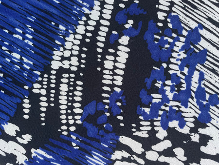 Fabric with scattered patterns, close-up as texture. Cotton or linen fabric with blue and black spots. Bright background.の写真素材