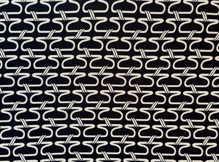 Abstract black and white pattern. Abstract grunge background. Halftone graphic effect. Fabric with scattered patterns, close-up as texture. Cotton or linen fabric. Dark background.の写真素材