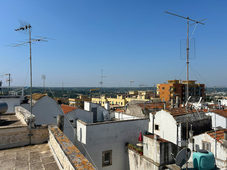 A town in Puglia, a region in southern Italy. White buildings, red tiled roofs and many antennas are very typical of this area. Church towers are visible, which is also typicalの写真素材