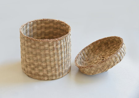 Wicker basket isolated on white background. Decoration concept of decorative natural plants, natural plants, basket close-up. Handmade wicker basket in different positions.の写真素材