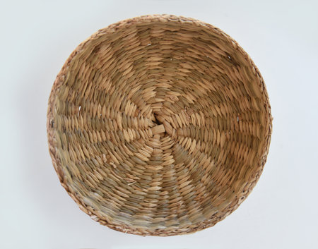 Wicker basket top view isolated on white background. Decorative natural plants decoration concept, natural plants, basket close up. Handmade wicker basket coverの写真素材
