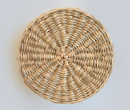 Wicker basket top view isolated on white background. Decorative natural plants decoration concept, natural plants, basket close up. Handmade wicker basket coverの写真素材