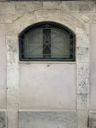 Old facade window of a building. Closed shutters in the window. Window facing a sunny street in Sicily, Italy.の写真素材
