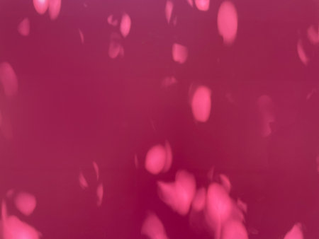 Abstract pattern of washed-out red shades. The background is a solid, soft red with a few lighter washed-out spots or shapes resembling highlights. Red background.の写真素材