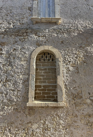 Old facade window of a building. Closed shutters in the window. Window facing a sunny street in Sicily, Italy.の写真素材