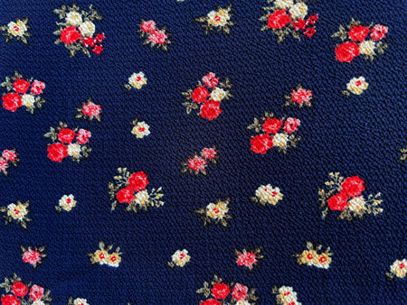 Fabric with a delicate floral pattern, close-up as texture. Old-fashioned cotton or linen textile in...