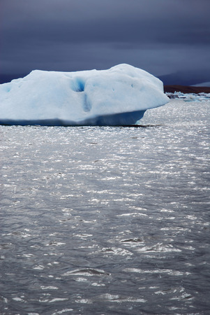A big white iceberg floating in Jokulsarlon (Jökulsárlón) -  large glacial lake in Iceland on the edge of Vatnajökull National Park before the stormの写真素材