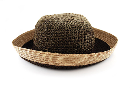 Straw plaited brown female hat with rolled-up sides - stylish design accessory and perfect protection against sun rays, object isolated on whiteの写真素材