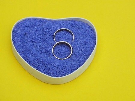 wedding rings made of wood with delicate blossoms in small stonesの写真素材