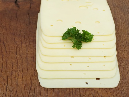 sliced cheese on a board from oakの写真素材