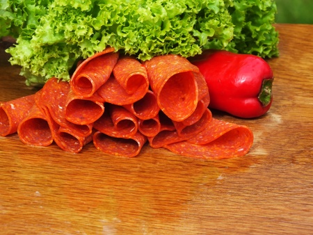 sliced sausage on a board from oakの写真素材