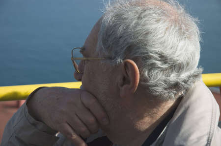 Close up of an elderly tourist in a bus tour with the blue sky of Naples in the background Elderly tourist in Naplesの写真素材