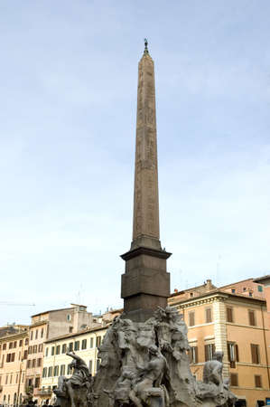Obelisk of Domitian in Piazza Navona  erected on top of the fountain designed by Bernini. The top of the obelisk is decorated with a dove. Rome, Italyの写真素材