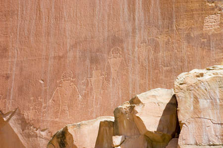 Petroglyph or rock carvings of Indians (Native Americans) on a canyon wall in Utah, USA, representing animals, figures, sheep, snakes, wildernessの写真素材