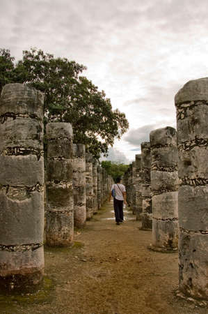 walking alone  among the  hundreds of stone columns at Chichen Itza, city of the new World seven wonders, mexico.の写真素材