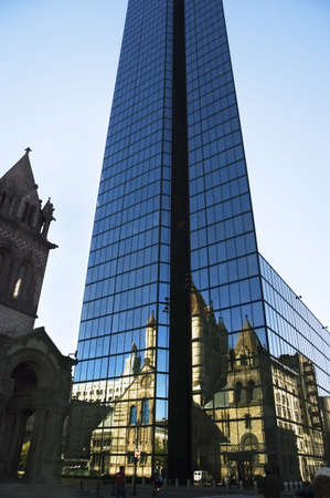 The 19th century romanesque Trinity Church reflecting on glasses of the Boston blue towerの写真素材