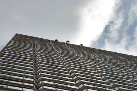 three windows washers suspendend in mid-air on the last floor of an highrise bulding, Boston, Mass