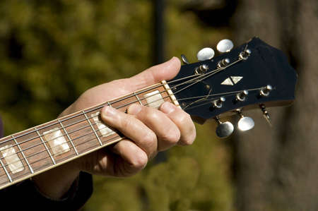 close view of a guitar handle and fingers
