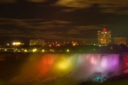 Niagara Falls by night with American skyscrapers on background の写真素材