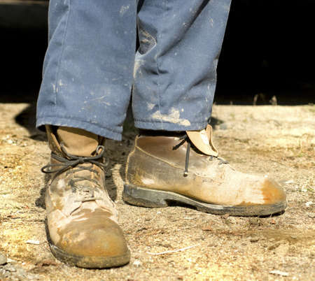 close up of old and dirty cement worker bootsの写真素材