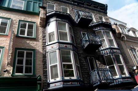 old decorated windows and  forged iron balconies on Quebec city, Canadaの写真素材