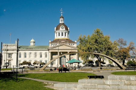 KINGSTON, ONTARIO - OCTOBER 19: tourists sit on a bench in front of city Hall of Kingston and Confederation arch fountain,  Ontario  Canada, 19 October 2008のeditorial素材
