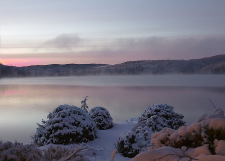 Sunset over a lake after snow storm at twilight time in Quebec, Canadaの写真素材