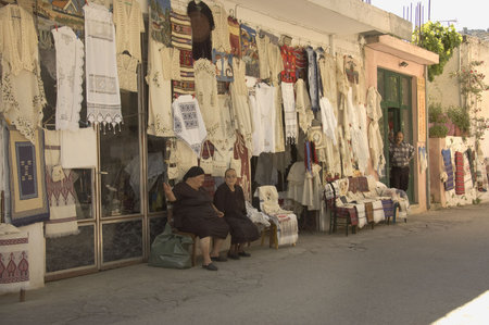 CRETE, GREECE - MAY 13TH;  Old ladies shopkeepers waiting for customers on the street of a Crete village, Greece, 13th May 2007のeditorial素材