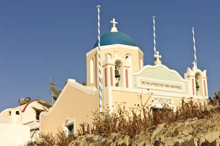 Oia , Santorini, Greece - May 16th, 2007; Blue dome  and pastel colored Greek church overlooking the caldera on Aegean Seaのeditorial素材