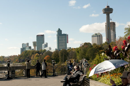 Ontario, Canada - October 16th, 2008 : crowd along the path of Niagara Falls with view on the city on background,, the Skylon tower and the Casino, Ontario, Canadaのeditorial素材