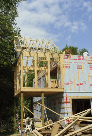Quebec, Canada - July 3th, 2006 : Frame of a residential house in construction with workers, in Quebec country Canadaのeditorial素材