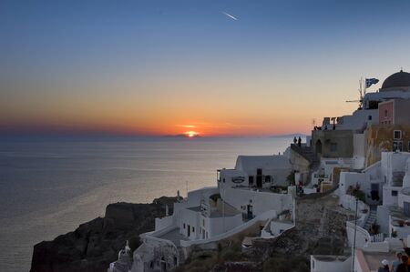 Santorini, Greece - May 16th, 2007 : people looking at sunset over Agean sea and Santorini, Oia village, Greeceのeditorial素材
