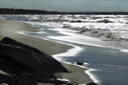 Michigan, USA - May 20th, 2006    Tide coming in and rolling over  the sandy beach of Lake Superior at twilight , Michigan , USAのeditorial素材