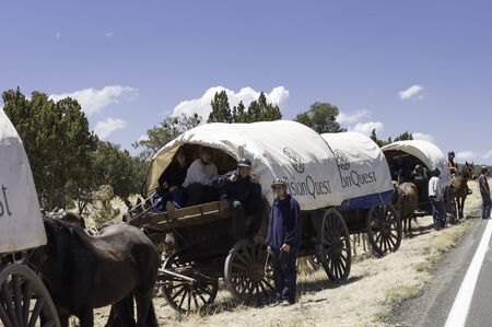 Tucson, Arizona, USA - April 26,2006   male juvenile traveling on covered wagons drawn by mules over the Western states  Wagon Train trips are operated by the VisionQuest rehabilitation program for youths in difficultiesのeditorial素材