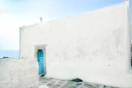 Old Orthodox church with blue door on the Aegean sea, Mykonos, Greeceの写真素材