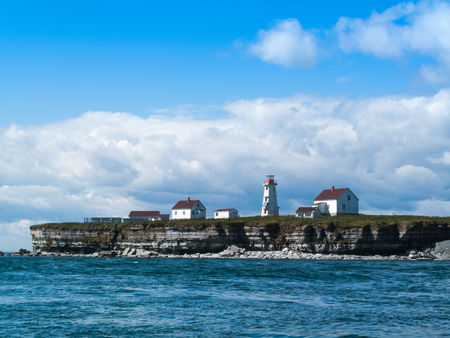 lighhouse and buildings in Longue-Pointe-de-Mingan on the St.Lawrence Gulf, Quebec, Canadaの写真素材