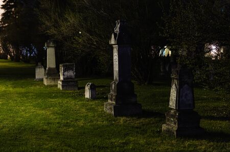 Weathered headstones  in St.Boniface  cemetery, Winnipeg, Canadaのeditorial素材