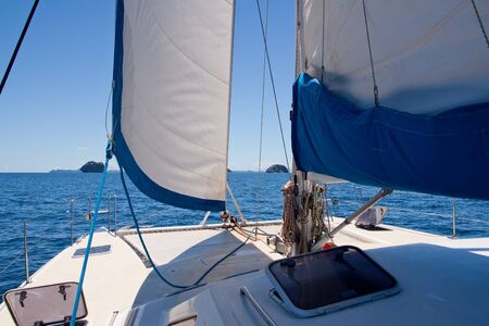 View of islands on the whiite luxury catamaran boatの写真素材