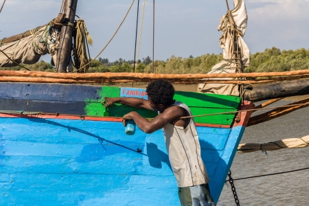 Malagasy man painting a dhow on oct. 29, 2007 near Morondava, Madagascar