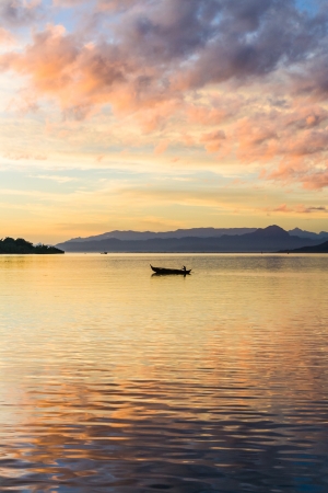 NOSY BE, MADAGASCAR - APR 4: unidentified people crossing the inlets in an outrigger canoe on april 4, 2008のeditorial素材