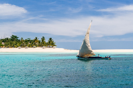 NOSY IRANJA, MADAGASCAR - APR 5: Fishing boat passing by the beach of Nosy Iranja, near Nosy Be, north of Madagascar on apr 5, 2008.のeditorial素材