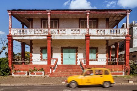 Colonial architecture typical of Diego Suarez (Antsiranana), north of Madagascar, with a typical taxi on october 14, 2016のeditorial素材