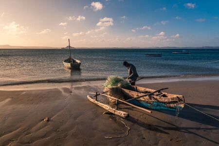 Antsiranana, Madagascar, October 13, 2016: A fisherman repairing his fishing net on the Ramena beach near Diego Suarez (Antsiranana)のeditorial素材