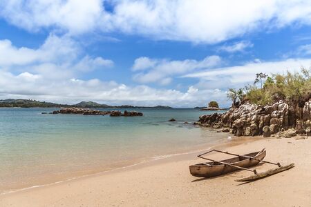 A typical outrigger canoe beached on Nosy Sakatia (Nosy Be), Madagascarの写真素材