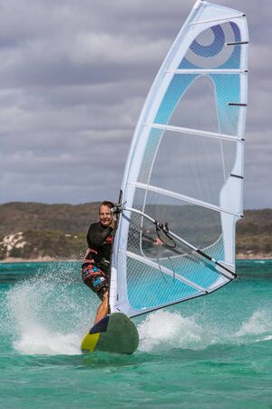 Men's windsurfer surfing in the lagoon
