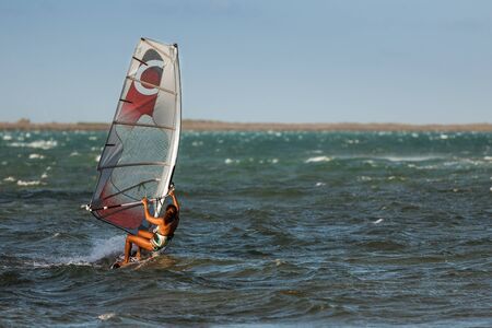 Woman windsurfing in the lagoonの写真素材