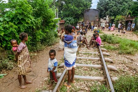 Fianarantsoa, Madagascar, March 8, 2013: Villagers waiting during a stop in a railway station of the FCE train (Fianarantsoa - East Coast)のeditorial素材