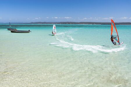 Couple of windsurfers in the vastness of the lagoonの写真素材